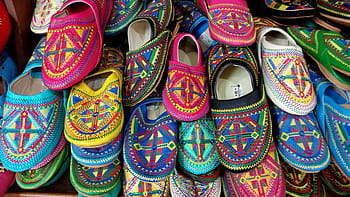 Morocco, babouche, colorful slippers, traditional footwear, Moroccan slippers, handcrafted shoes, vibrant patterns, ethnic shoes, cultural accessories, market display, artisanal products