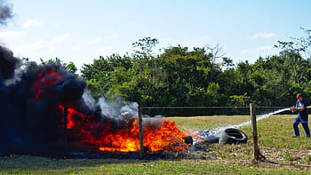 fire, fire fighter, emergency, tires, water, spray, douse, fence, rural