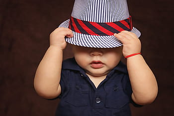 baby, wearing, blue, top, white-and-blue fedura, boy, hat, covered, eyes, playing, photos