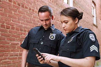 police woman, holding, phone, man, bodyworn, body camera, police body camera, law enforcement, cops, law enforcing, policeman