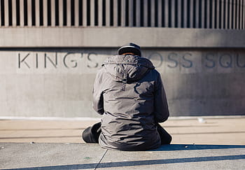 person, wearing, grey, hoodie, sitting, ground, selective, focus, photography, man, gray