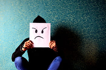 person, holding, sad, sketch board, man, angry, irritated, unhappy, mask, face, sitting