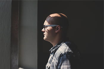 man, standing, facing, window, wearing, white, temple eyeglasses, guy, eyeglasses, bald, people
