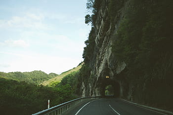 gray, concrete, road midst tunnel, asphalt, road, leading, tunnel, sky, winding, hills, grass