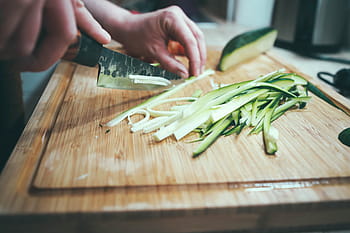 person chopping vegetable, chopping, board, kitchen, utensils, knife, food, vegetable, cucumber, hand, cutting