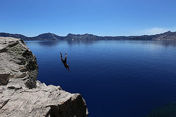 man, diving, lake, water, cold, cliff, blue sky, clear, still, calm, adventure