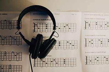corded, headphones, music note, headset, music, black, speaker, paper, indoors, arts culture and entertainment, people