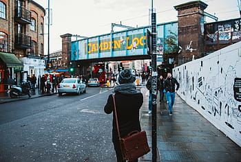 people, standing, walking, street, buildings, daytime, road, beanie, city, bag, back