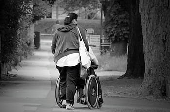 grayscale photography, woman, pushing, wheelchair, help, women, old, street, accessible, senior, handicapped