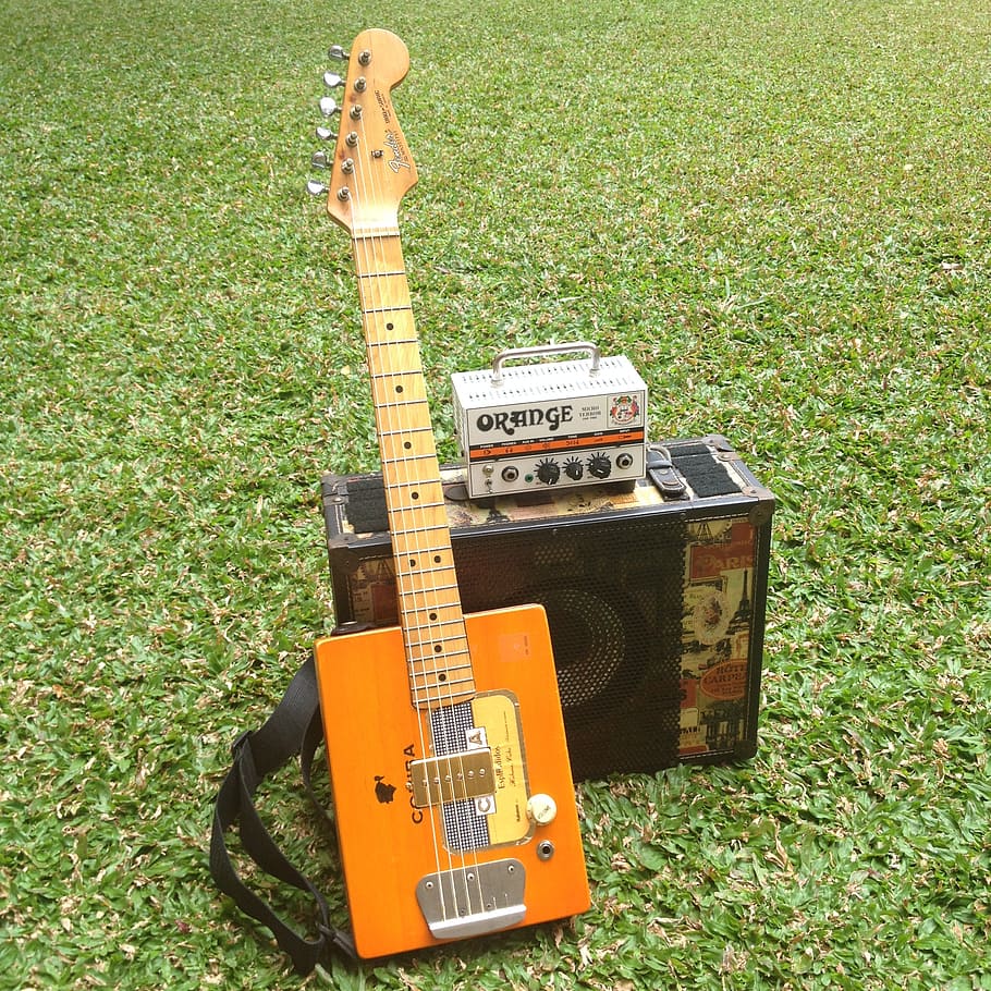 guitar, amplifier, speaker, cabinet, park, grass, orange, green, music, cigar box, instrument