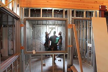 man, wearing, black, shirt, standing, gray, steel frame, construction, building, window, framing
