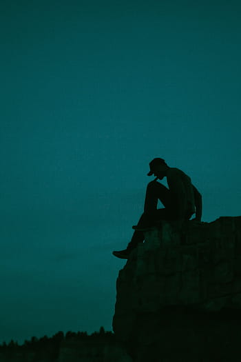 silhouette photo, man, sitting, cliff, edge, stone, guy, silhouette, dark, night, evening
