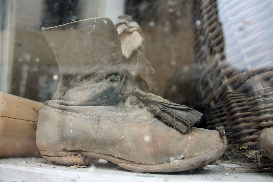 old boot in window, ancient shoe, old window display, dirty window, dirty old boot