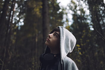 boy, looking, surrounded, trees, daytime, person, wearing, gray, hoodie, jacket, right