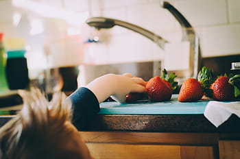 brown wooden sideboard, people, kid, baby, child, strawberry, fruit, food, kitchen, domestic kitchen, domestic room