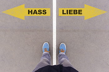 person, standing, gray, road, love, hate, german, text, language, written, letters