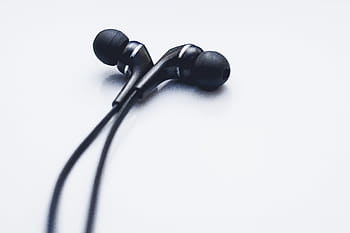 close-up photo, black, earbuds, grey, earphones, cord, music, white background, studio shot, indoors, close-up