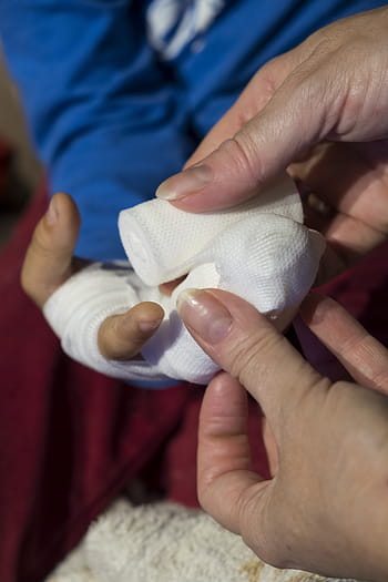 person, holding, white, gauze, child, boy, injury, injured, association, bandages, patch