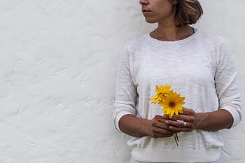 woman, holding, flower, wall, background, copy space, lady, girl, feminine, beautiful, elegant