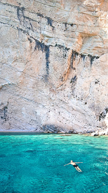 man, floating, sea, cliff, person, swimming, body, water, near, rocky, mountain