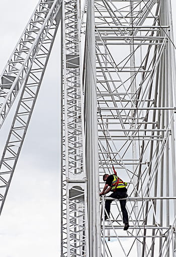 man climbing tower, construction, safety, danger, height, working, building, harness, risk, peril, truss