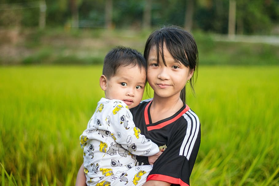 girl, carrying, baby, grass field, country, cute, eye, kids, nice, vietnamese, two people
