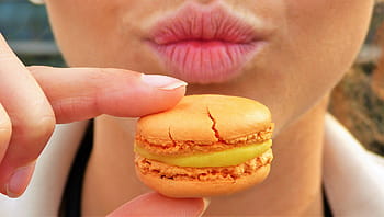person, holding, macaroon, daytime, macaron, orange, sweetness, pastries, mouth, lips, girl