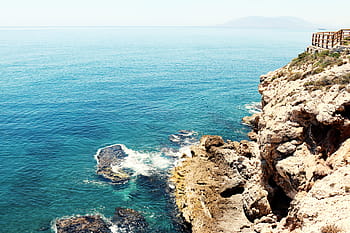 white, rock mountain, body, water, daytime, stone, structures, near, shore, sea, ocean