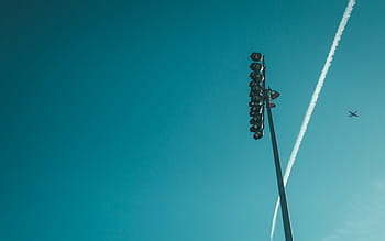 low-angle photography, flying, plane, daytime, black, track, lights, jet, clouds, blue, sky