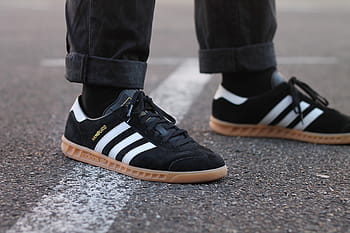 person, wearing, black, adidas superstar low-top sneakers, shoes, footwear, jeans, road, travel, shoe, men