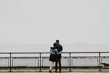 man, woman, standing, black, steel fence, people, couple, love, water, ocean, sea