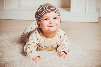 baby, wearing, brown, sleep, suit, gray, knit, cap, white, fur floor rug, babe